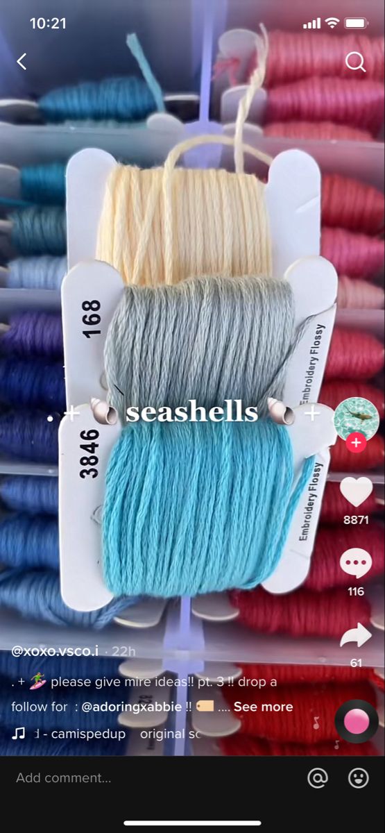 several skeins of yarn are on display in a case with the words seashells above them