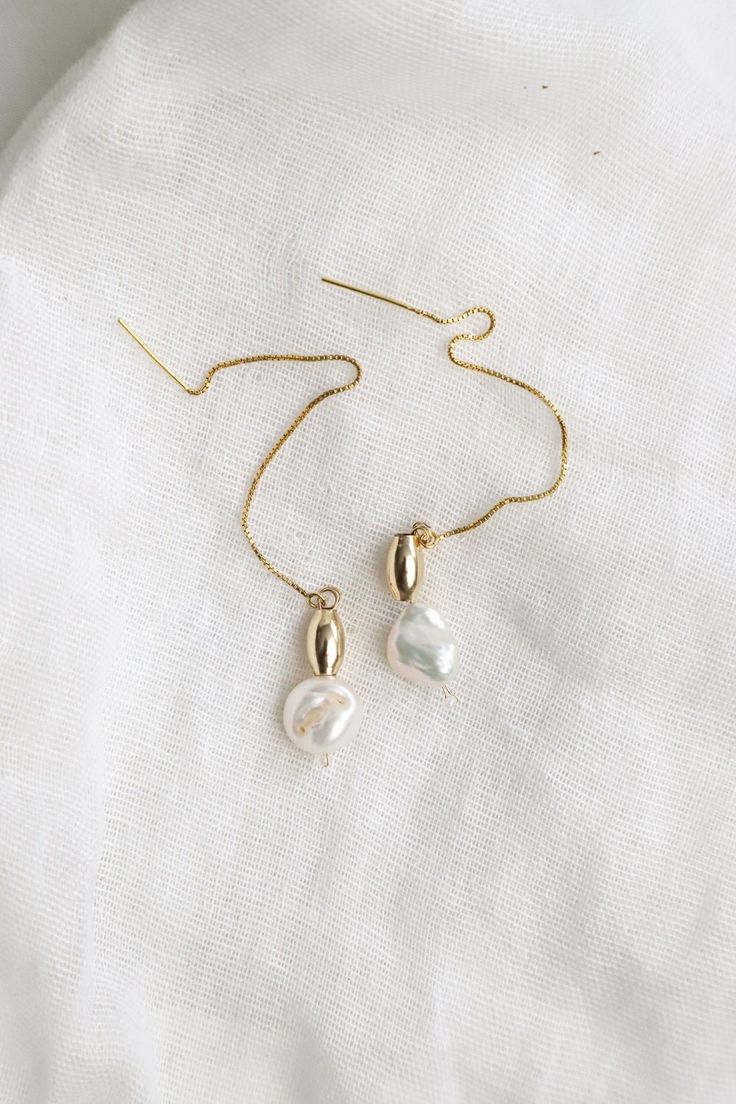 A fresh-water pearl matched with a real 14K gold-filled bead hang on a real gold-filled chain. Threaded through the ear for a double dangle - in the front and the back. A classy and timeless piece to add to your jewelry box. Please support my brand new shop :) I'm a tiny, Canadian business owner and make each pair of earrings with plenty of love. Minimalist Pearl Chain 14k Gold Filled Earrings, Minimalist Pearl Chain Earrings In 14k Gold Filled, Minimalist 14k Gold Filled Pearl Chain Earrings, Everyday 14k Gold Filled Pearl Chain Earrings, 14k Gold Drop Pearl Earrings With Pearl Chain, 14k Gold Pearl Chain Drop Earrings, Yellow Gold Pearl Chain Teardrop Earrings, Gold Minimalist Drop Pearl Earrings, Gold Sterling Silver Pearl Chain Earrings