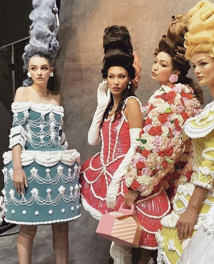 three women in colorful dresses standing next to each other