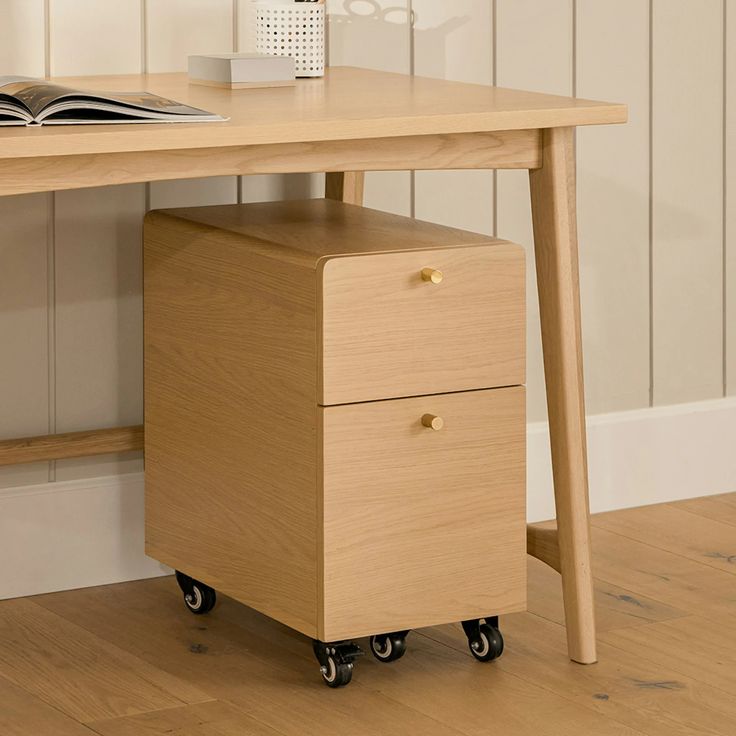 a wooden desk with two drawers and a book on it