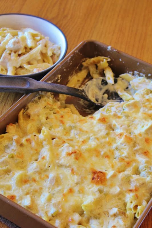 a casserole dish with chicken and noodles in it next to a bowl of macaroni and cheese