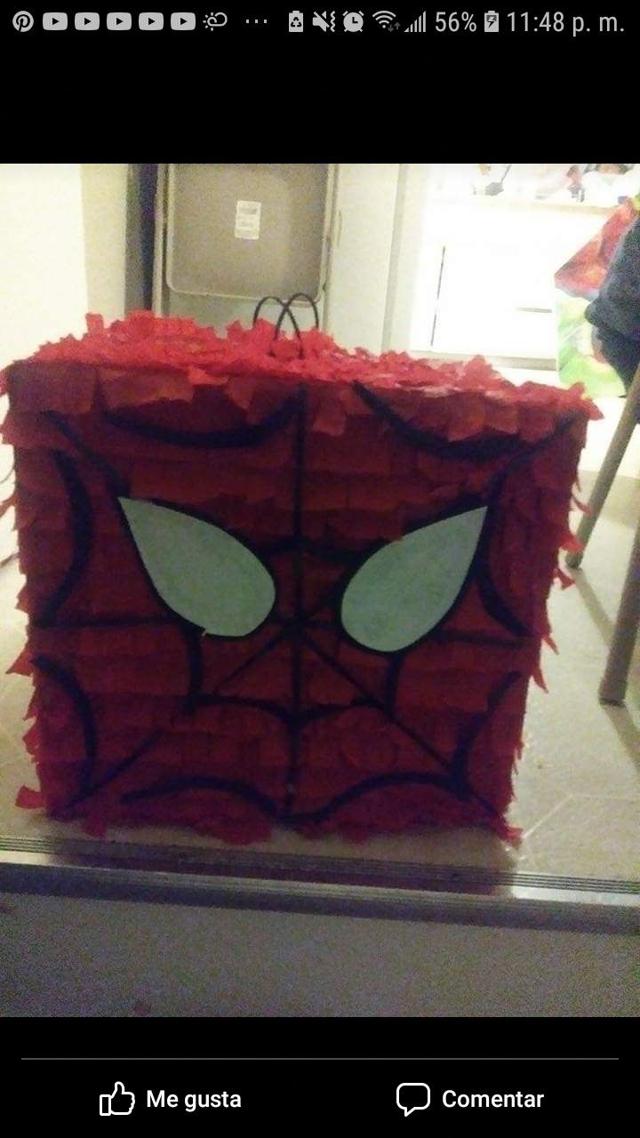 a spiderman box made out of red tissue paper with eyes on the front and bottom