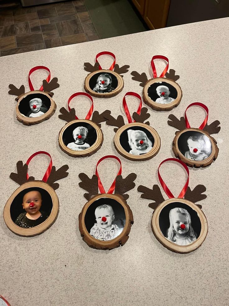 a group of christmas ornaments hanging on a counter top with a baby's face in the center