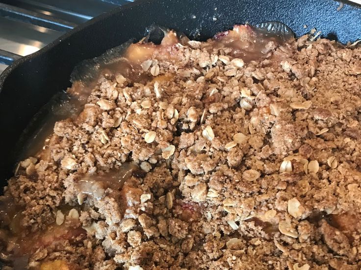 a skillet filled with food sitting on top of a stove