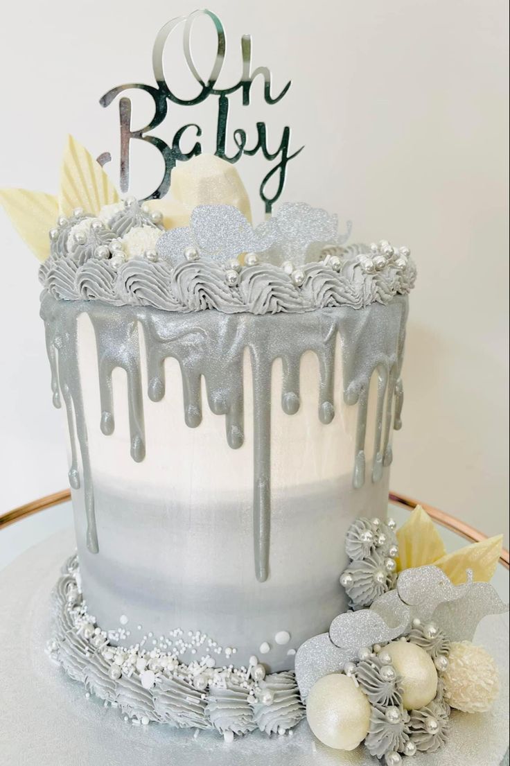 a birthday cake with icing and decorations on it's side, sitting on top of a table