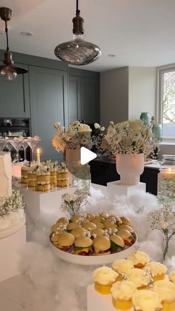 a table filled with cakes and cupcakes covered in frosting