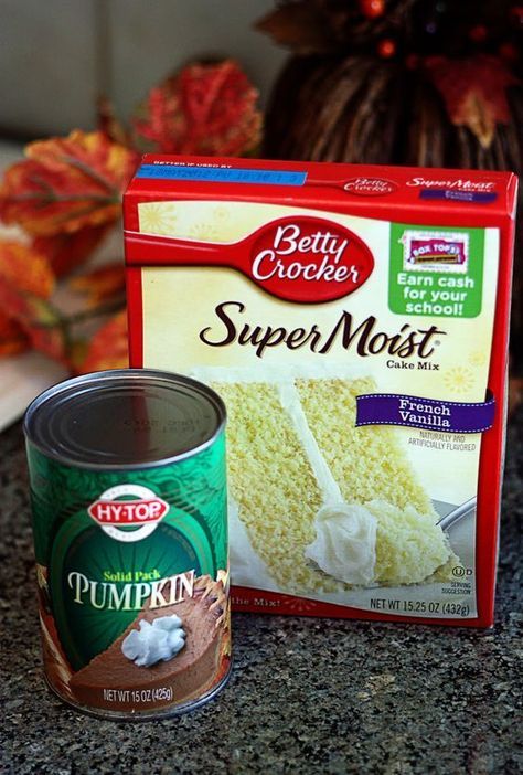 a can of cake next to a package of frosted pumpkins on a counter