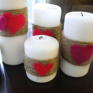 three candles with hearts on them sitting on a table