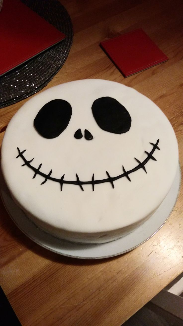 a white cake decorated to look like jack skellingy