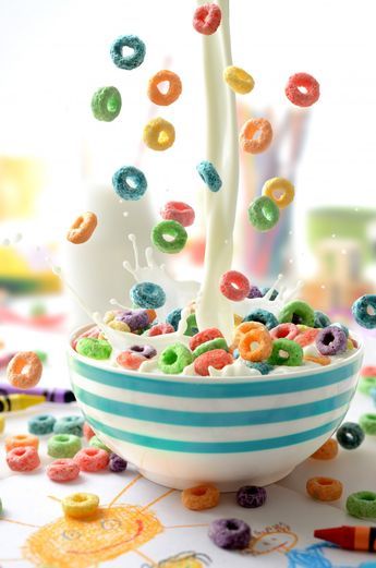 a bowl filled with cereal and sprinkles on top of a table