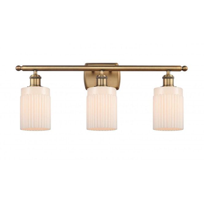 three light bathroom fixture in an antique brass finish with frosted glass shades and gold accents