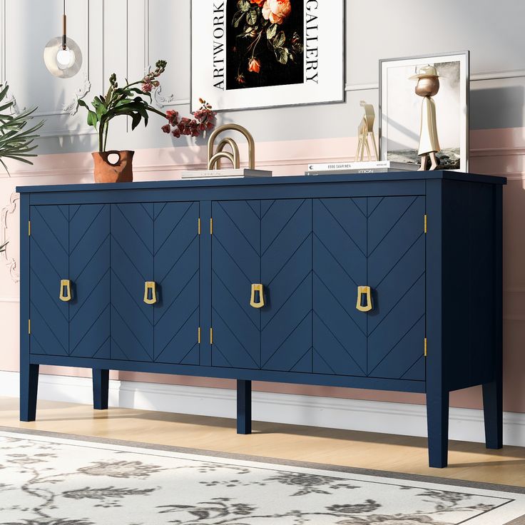 a blue cabinet with gold handles and knobs in a pink living room, next to a painting on the wall