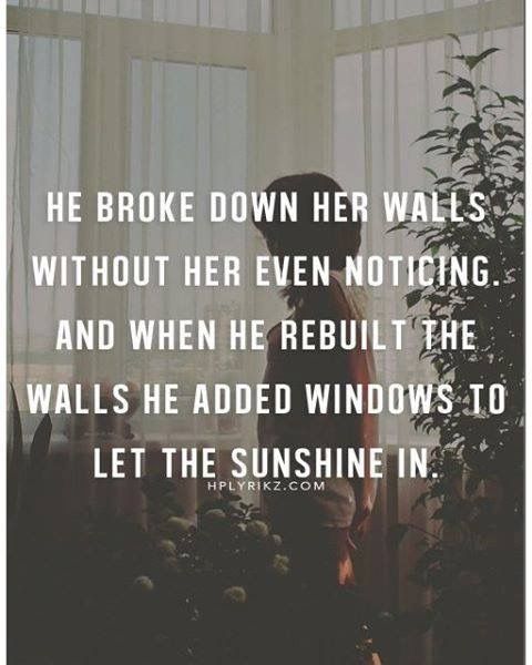 a person standing in front of a window with the quote he broke down her walls without her even noticeing and when he rebuilt