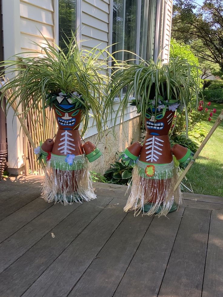 two potted plants are sitting on the porch