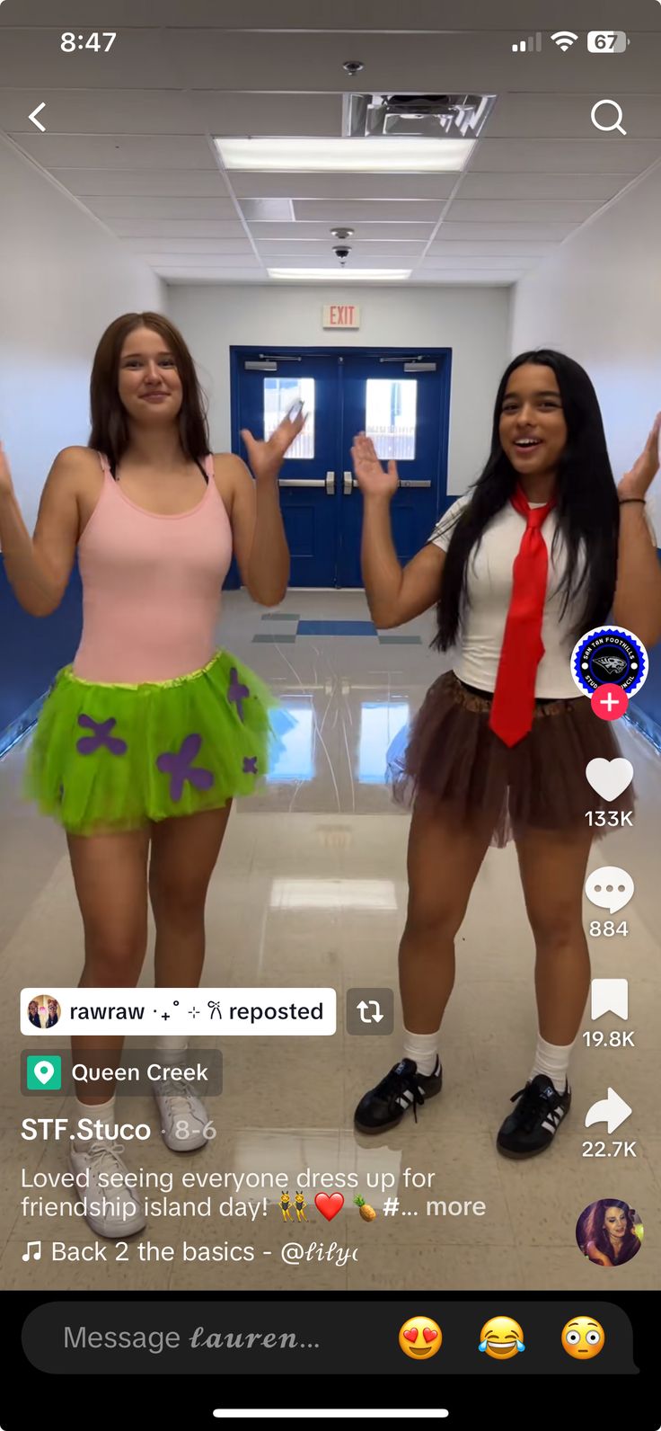 two young women dressed in costumes standing next to each other with their hands up and smiling