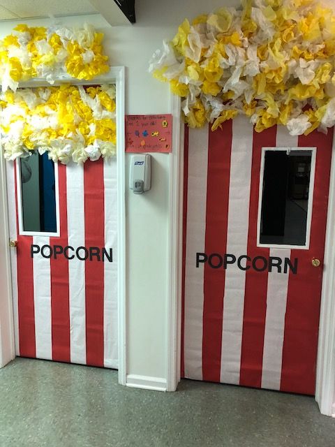 two red and white striped doors with popcorn written on them, next to each other