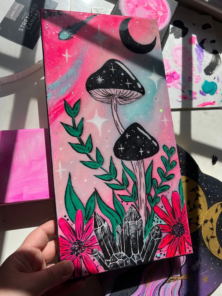 someone is holding up a card with mushrooms and flowers on it in front of other cards