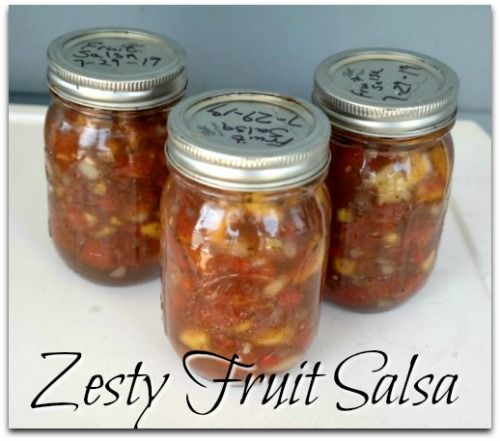 three jars filled with food sitting on top of a white counter next to the words zesty fruit salsa