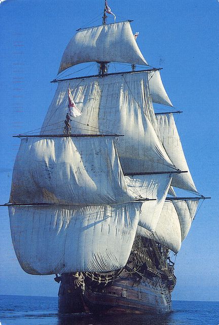 an old sailing ship in the middle of the ocean