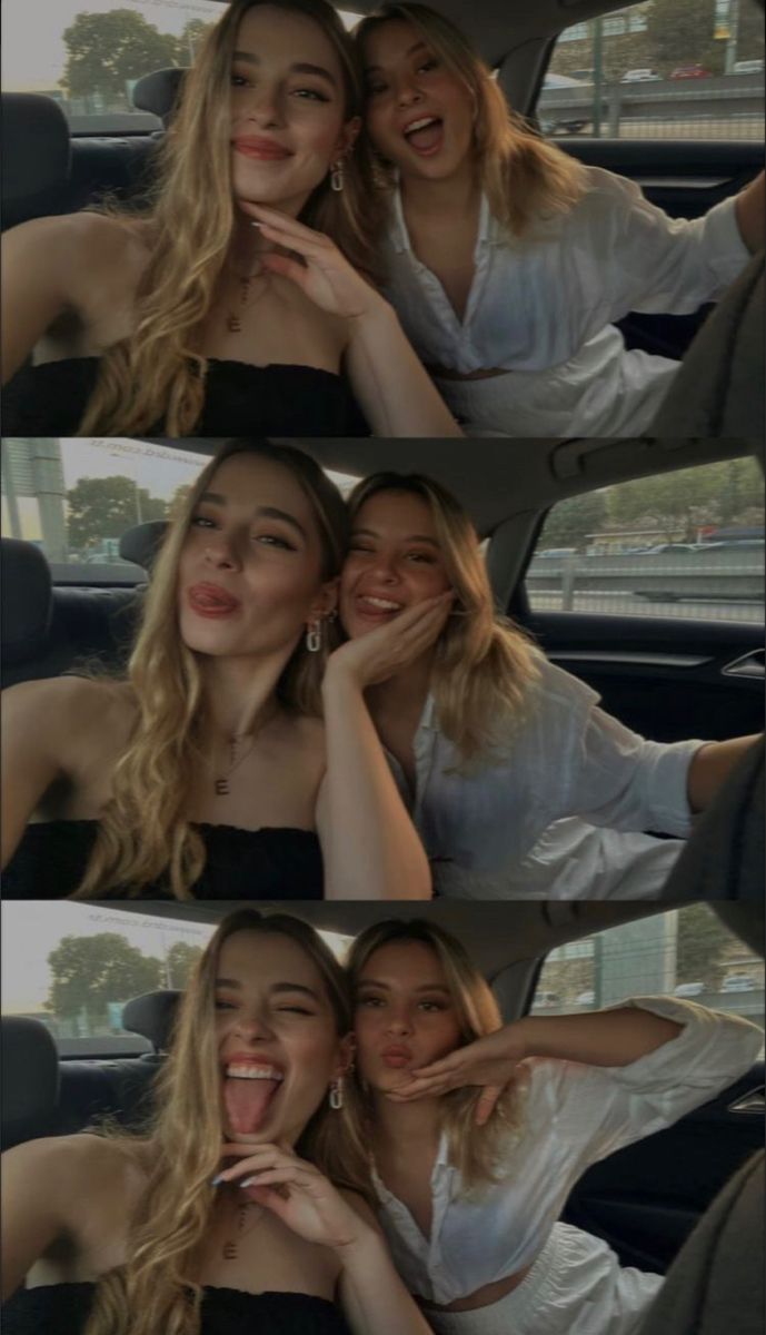 two beautiful women sitting in the back seat of a car