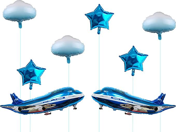 blue and white balloons floating in the air next to an airplane shaped boat with stars on it