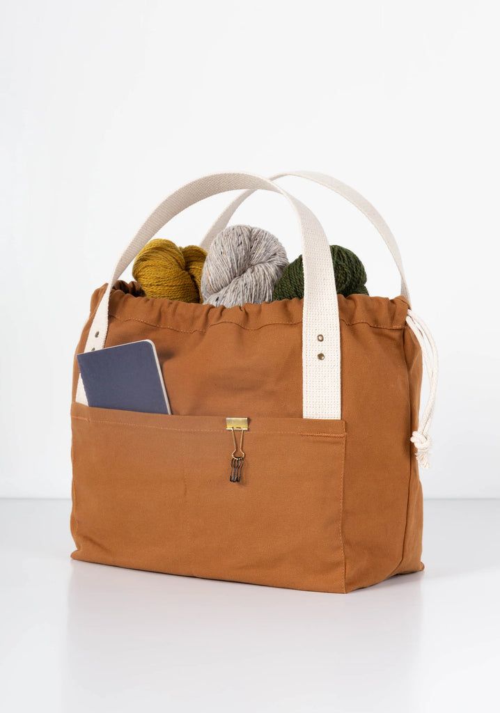 a bag filled with balls of yarn sitting on top of a table