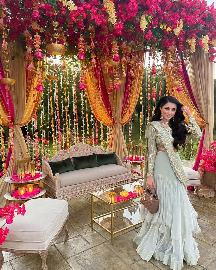 a woman standing in front of a decorated stage