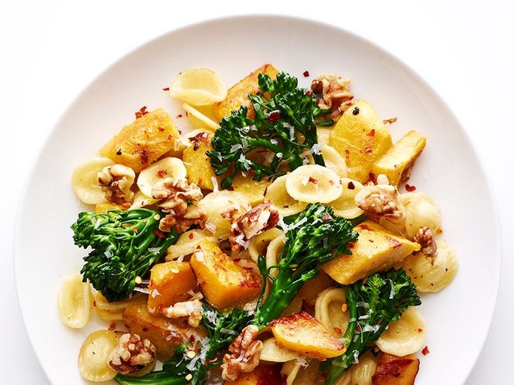 a white plate topped with pasta and broccoli