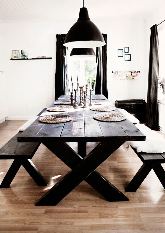 a dining room table with two benches in front of it