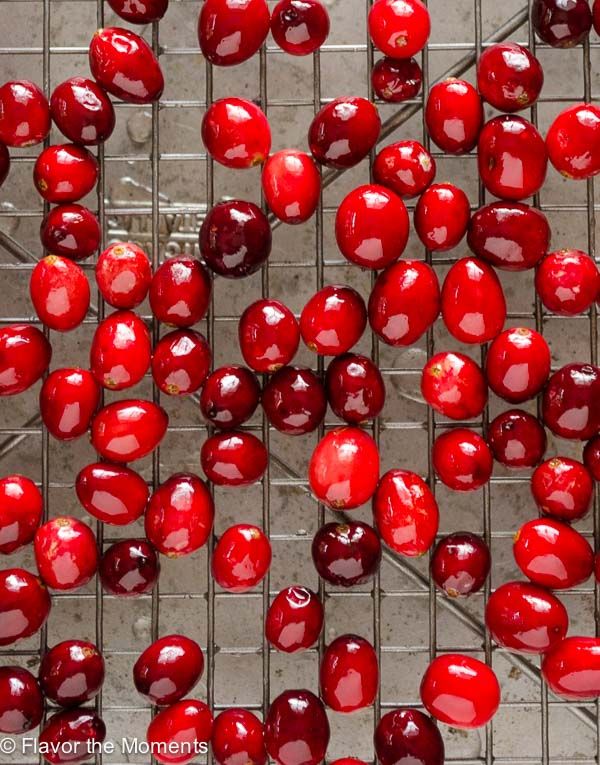 red cherries are arranged on a metal grate