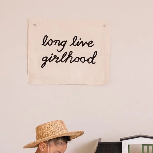 a young boy wearing a straw hat sitting at a desk