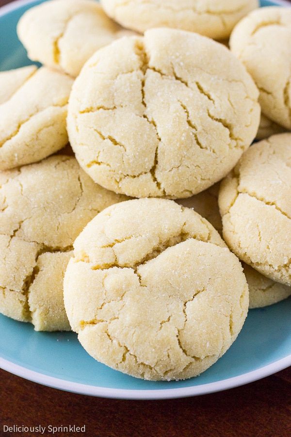 a blue plate filled with cookies on top of a wooden table