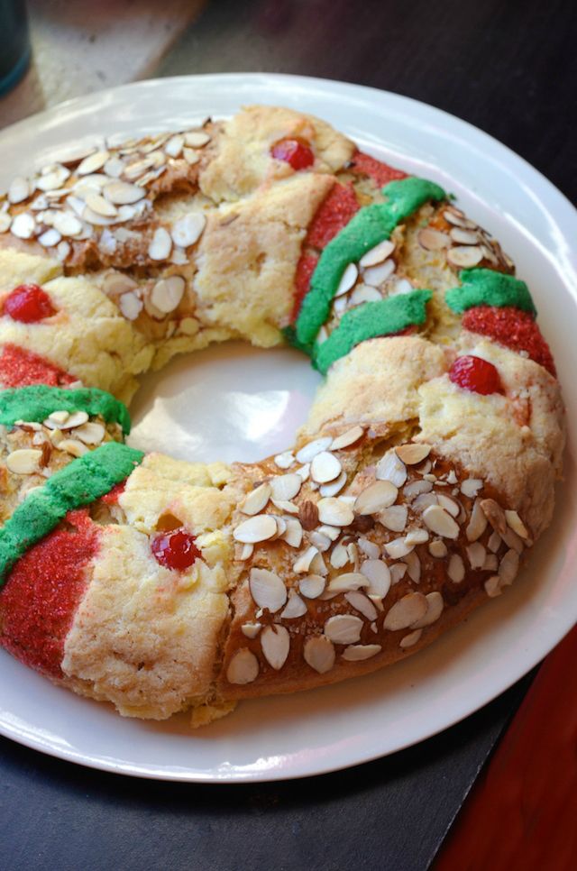 a white plate topped with a cake covered in frosting and sprinkles