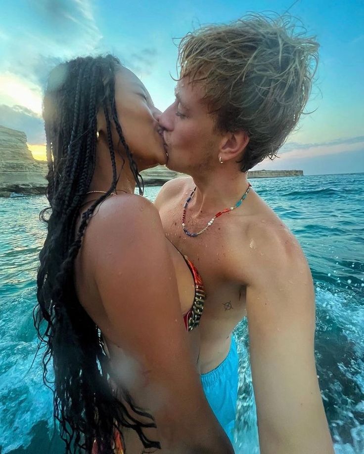 two people are kissing in the water