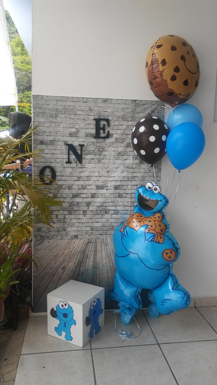 some balloons are in the shape of sesame street characters and one has a cookie monster on it