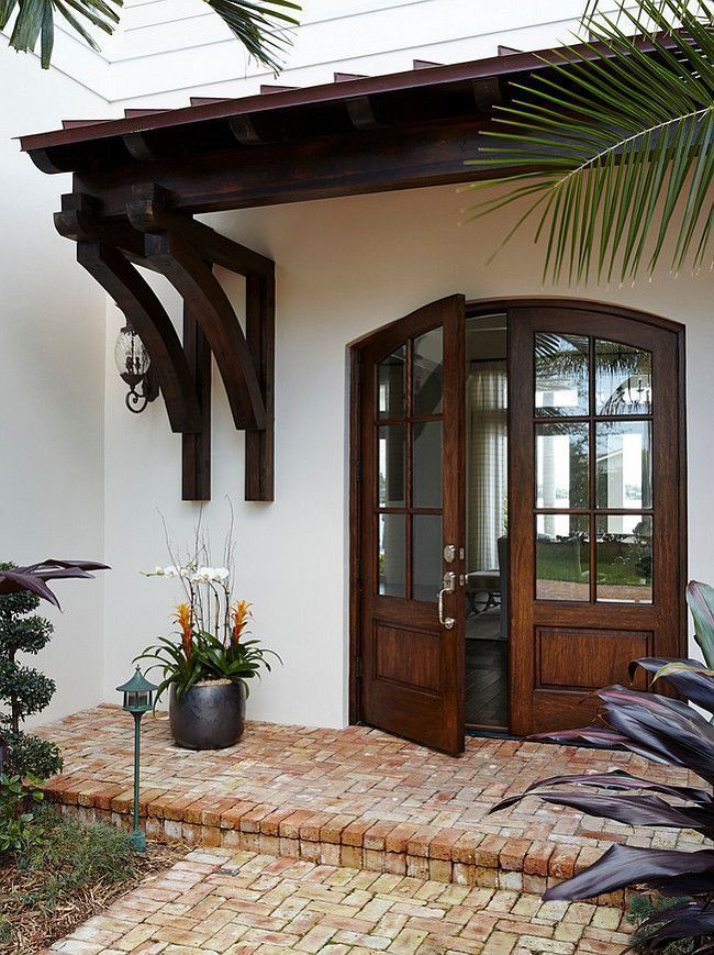 the entrance to a home with brick walkway