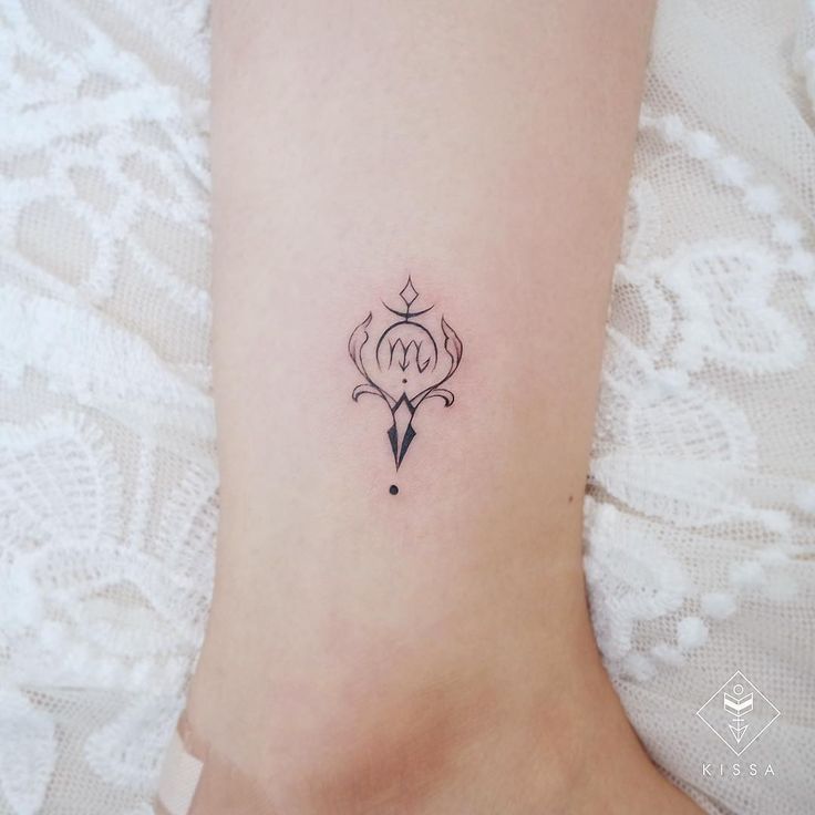 a woman's foot with a small tattoo on the left side of her leg