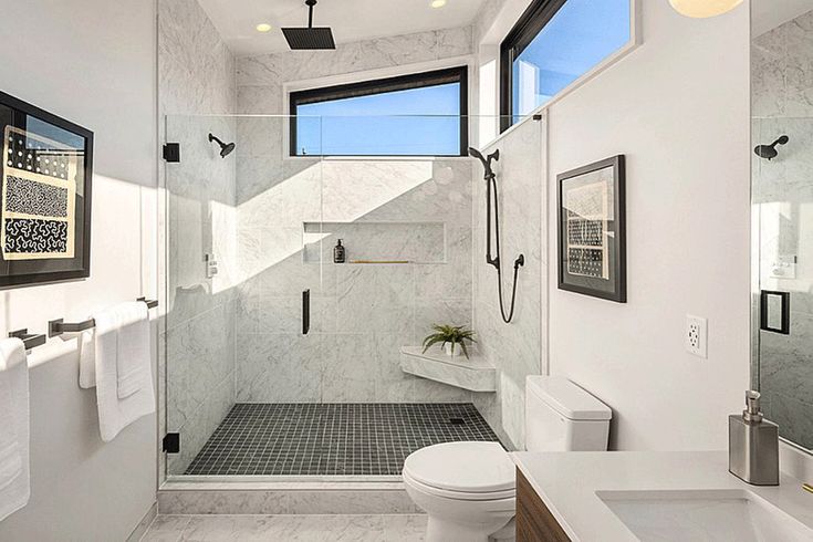 a bathroom with a toilet, sink and shower