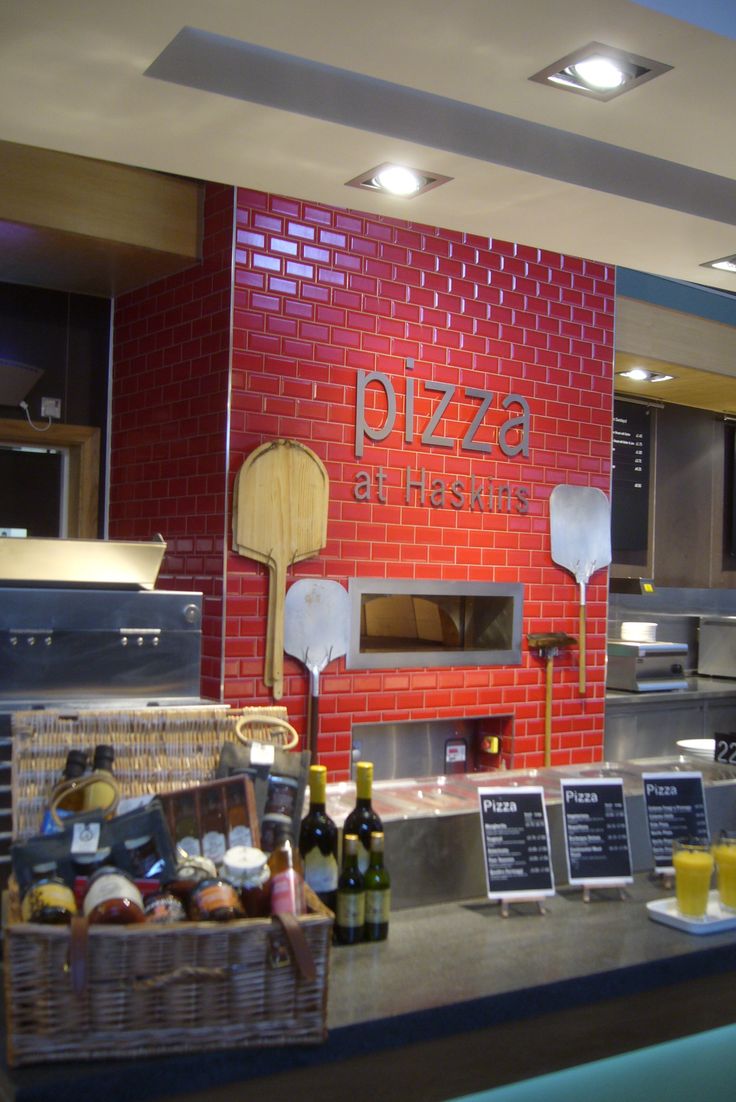 there is a pizza and other food items on the counter in this restaurant bar area