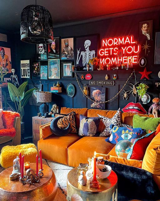 a living room filled with orange couches and colorful pillows on top of each other