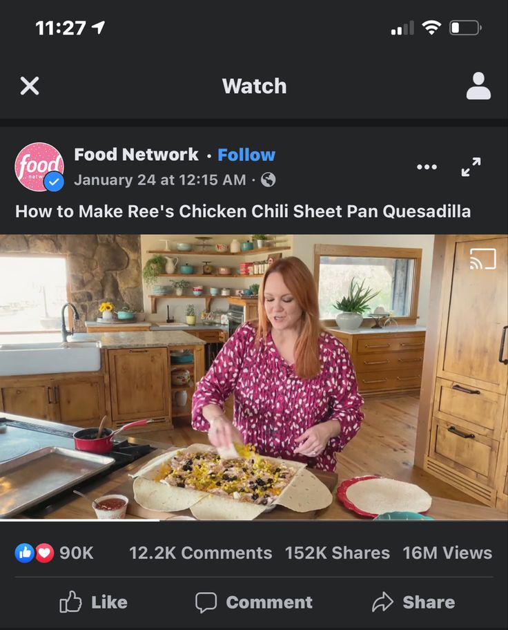 a woman is cooking food in the kitchen on her cell phone, and it's time to cook