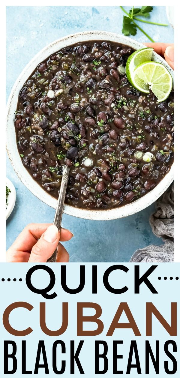 a bowl filled with black beans and topped with lime