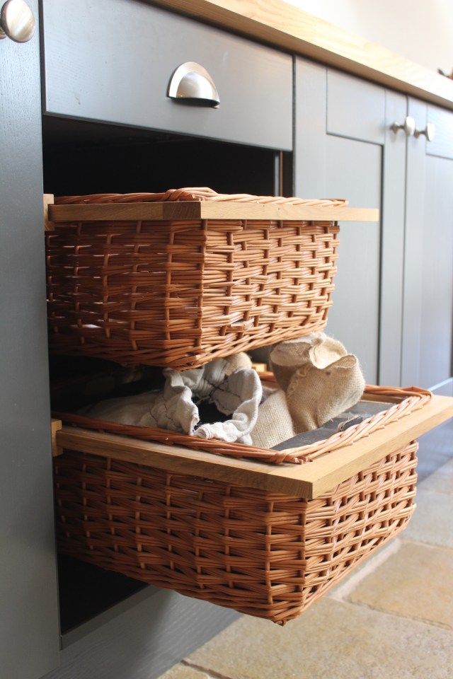 two wicker baskets are stacked on top of each other in front of an oven