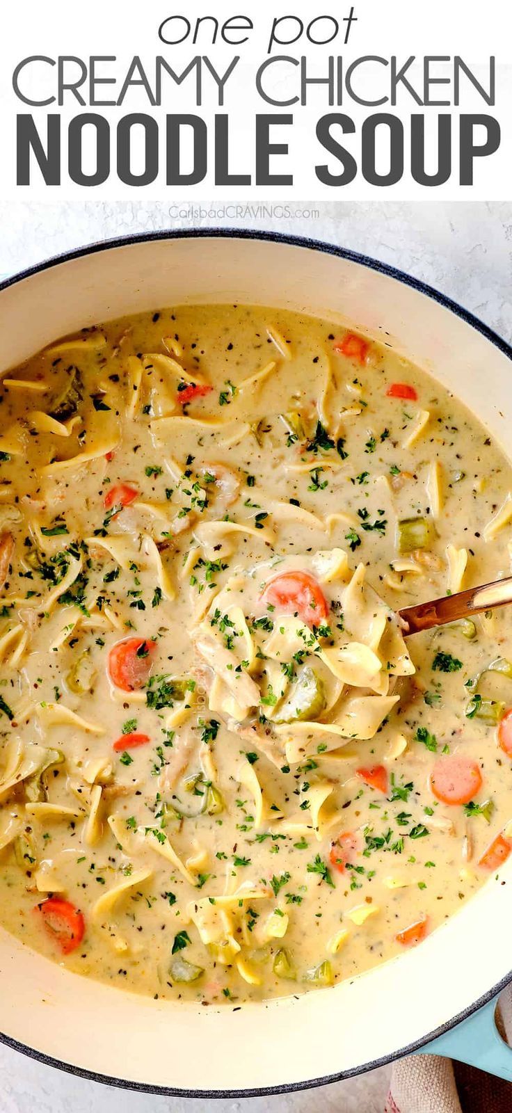 creamy chicken noodle soup in a white bowl