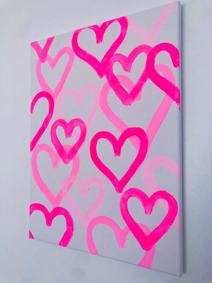 a pink and white painting with hearts painted on it