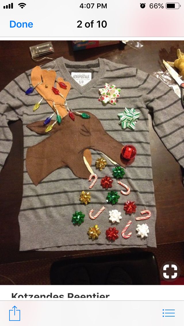 an ugly sweater is on the table with candy canes and candies all over it