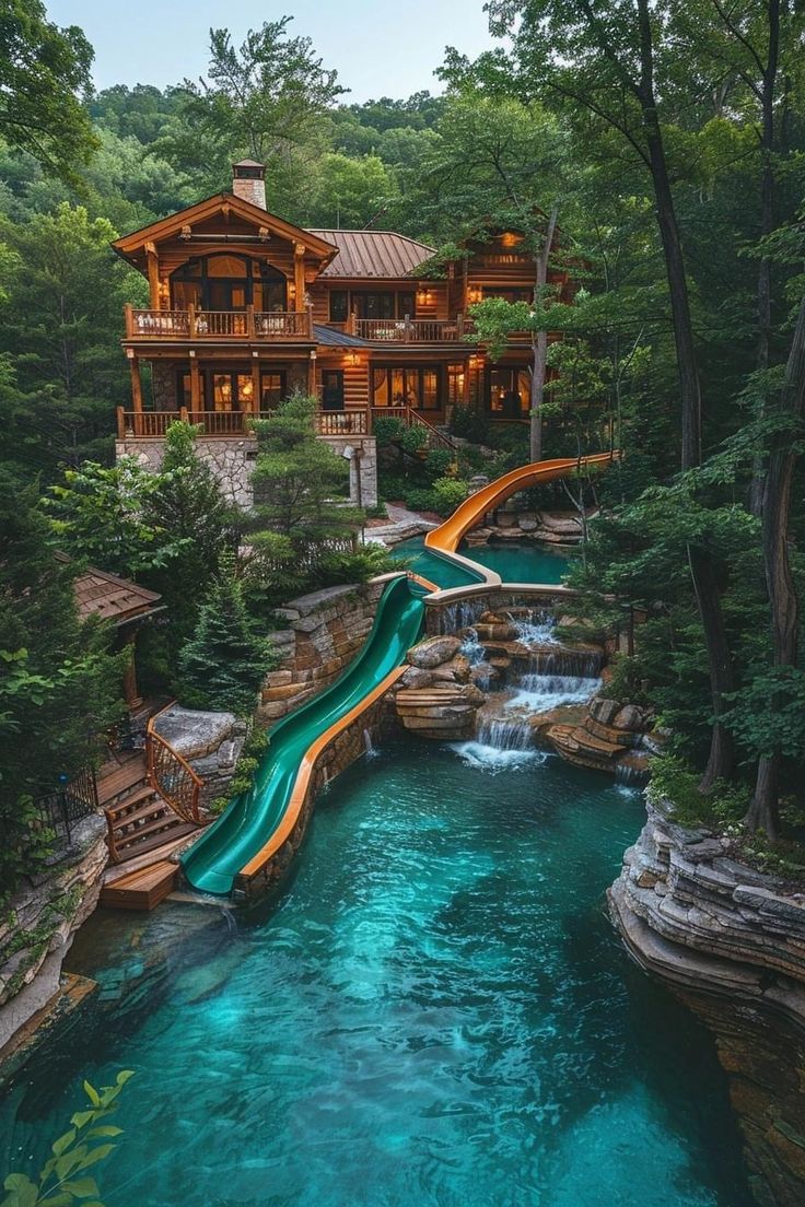 a water slide is in the middle of a pool surrounded by trees and other greenery