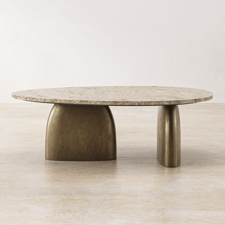 a round table with two legs and a marble top, on a beige tile floor