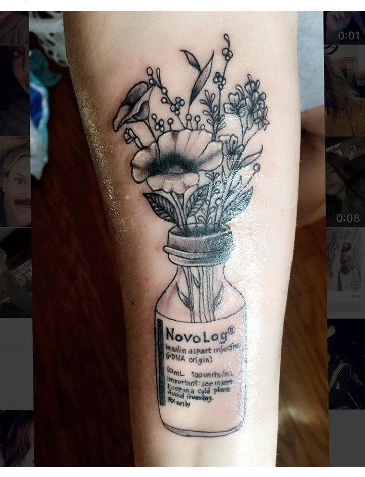 a tattoo with flowers in a jar on the left arm and an inscription below it