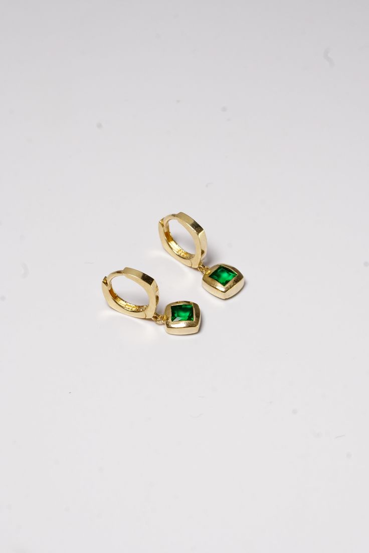 PLX059 Our Green Stone Square Bold Hoop Earrings are meticulously handcrafted in Korea. They beautifully blend classic and contemporary style, making them a unique piece of jewelry. Made from 14K solid gold and adorned with green stones in a square design, these earrings not only offer durability but also emanate a sophisticated charm. Their bold hoop design is perfect for adding a striking and stylish touch to your everyday look or for special occasions. These earrings also make a thoughtful gi Gold Plated Yellow Gold Hoop Earrings With Gemstone, Green 14k Gold Hoop Earrings, Elegant Green 14k Gold Huggie Earrings, Green Huggie Fine Jewelry Earrings, Green Huggie Earrings Fine Jewelry, Ornate Yellow Gold Emerald Hoop Jewelry, Green Gold Plated Earrings Fine Jewelry, Green 14k Gold Huggie Earrings, Green Plated Drop Earrings